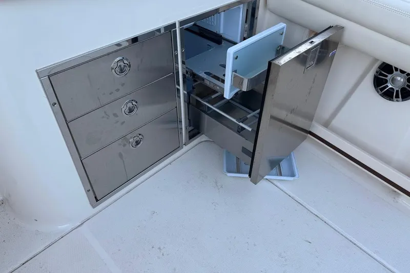 Slide: The Image of Stainless steel storage drawers on 2022 Grady-White Freedom 335 boat interior. - 10