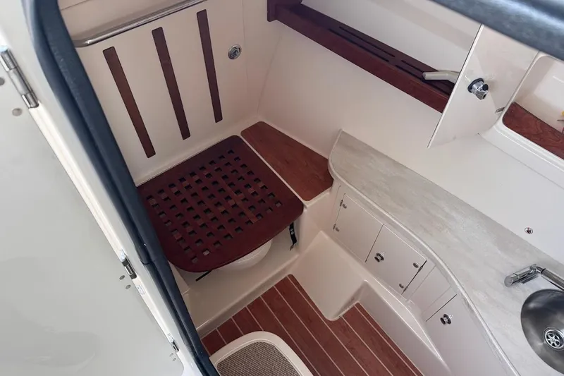 Slide: The Image of 2022 Grady-White Freedom 335 boat interior with wooden accents and cabinetry. - 17