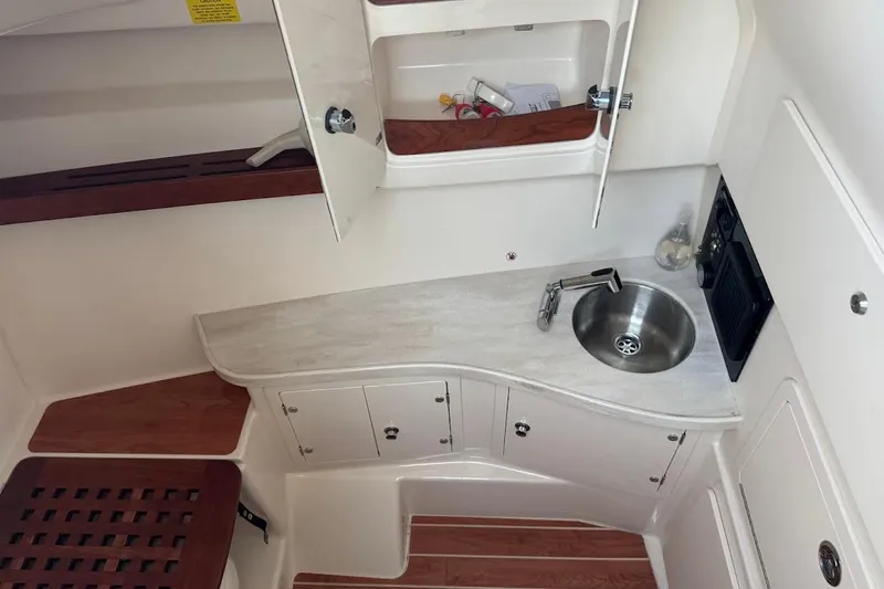 Slide: The Image of 2022 Grady-White Freedom 335 boat interior with sink and storage cabinets. - 18