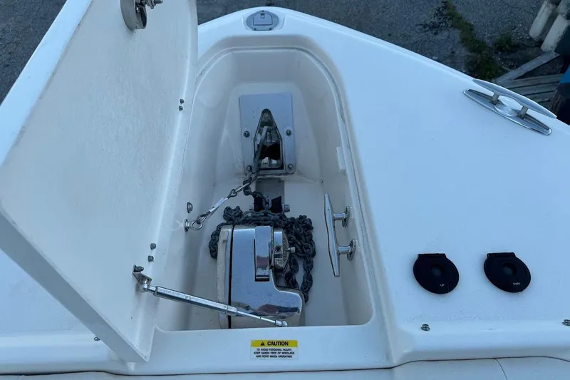 Slide: The Image of Anchor compartment of 2022 Grady-White Freedom 335 boat with chain and controls. - 20