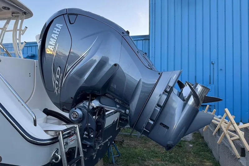 Slide: The Image of 2022 Grady-White Freedom 335 with Yamaha outboard motor, parked near blue building. - 3