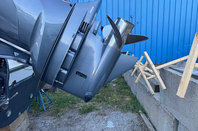 Slide: The Image of 2022 Grady-White Freedom 335 boat engine propeller close-up, blue background. - 4