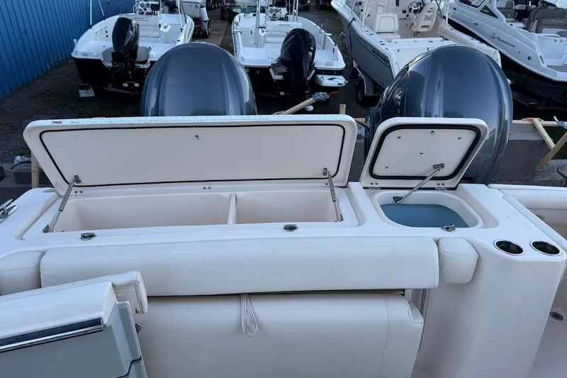 Slide: The Image of 2022 Grady-White Freedom 335 boat with open storage compartments and dual engines. - 7