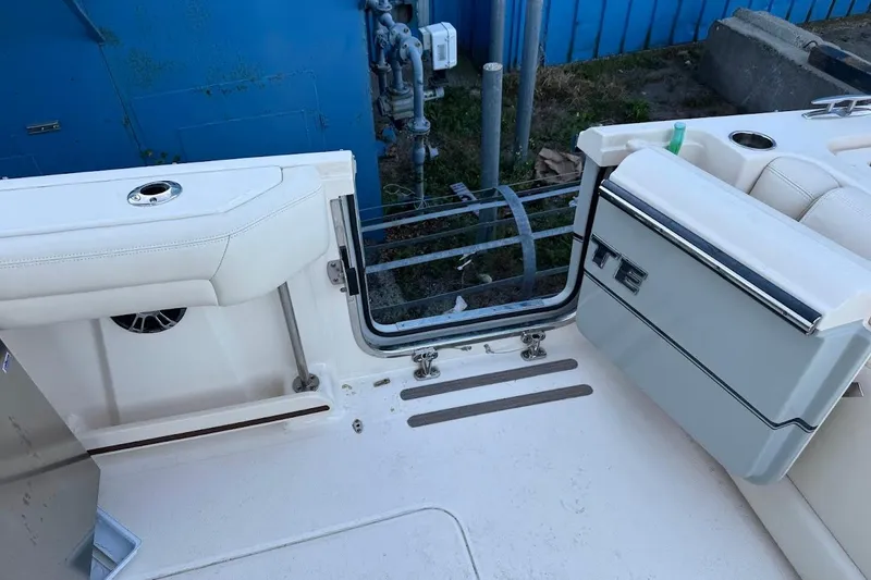 Slide: The Image of 2022 Grady-White Freedom 335 boat interior with open transom door. - 9