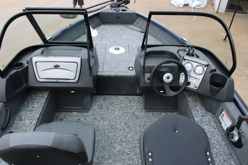 Slide: The Image of 2026 Tracker Pro Guide V-16 WT boat interior with steering wheel and seating. - 5