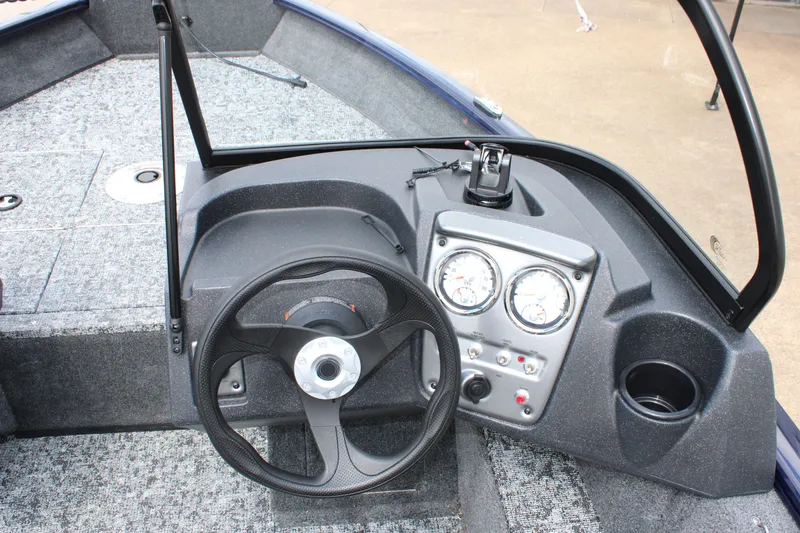 Slide: The Image of 2026 Tracker Pro Guide V-16 WT boat dashboard with steering wheel and gauges. - 10