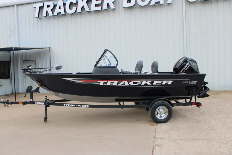 The Image of 2026 Tracker Pro Guide V-16 WT boat on trailer outside dealership. - 0