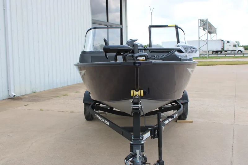 Slide: The Image of 2026 Tracker Pro Guide V-16 WT boat on trailer, parked outdoors. - 2