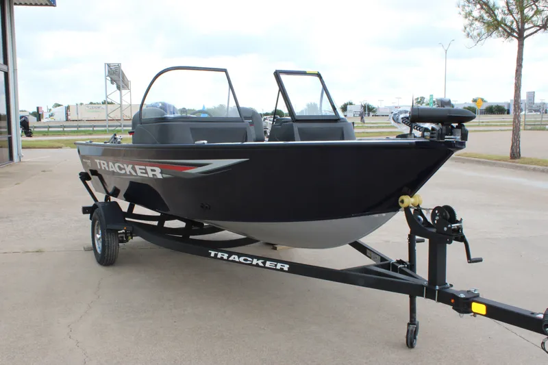 Slide: The Image of 2026 Tracker Pro Guide V-16 WT boat on trailer, parked outdoors. - 3
