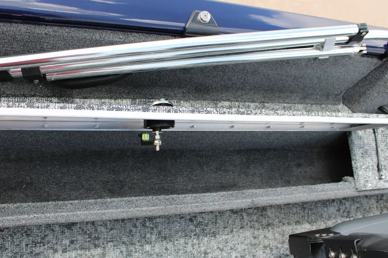 Slide: The Image of 2026 Tracker Pro Guide V-16 WT boat interior storage compartment with rod holder. - 11