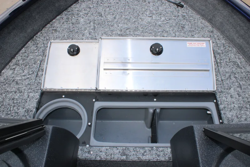Slide: The Image of 2026 Tracker Pro Guide V-16 WT boat interior with storage compartments and carpeted flooring. - 8