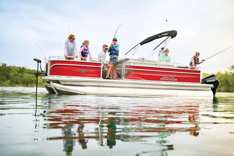 The Image of 2026 Sun Tracker Fishin' Barge 22 XP3 pontoon boat on trailer at Aqua Marine. - 0