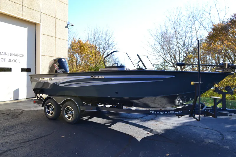 The Image of 2026 Ranger VX1988 WT boat on trailer, parked near maintenance building. - 0