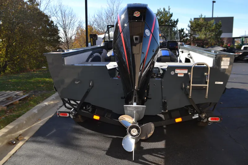 Slide: The Image of 2026 Ranger VX1988 WT boat with powerful outboard motor, parked outdoors. - 2