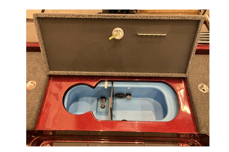 Slide: The Image of Open storage compartment in a 2026 Nitro ZV20 boat, featuring a blue interior. - 7