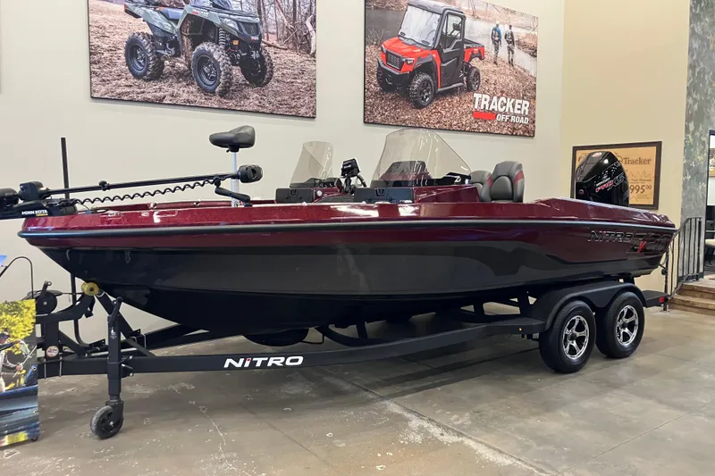 The Image of 2026 Nitro ZV20 boat on display in showroom, featuring sleek design and dual-axle trailer. - 0
