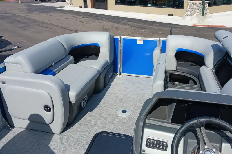 Slide: The Image of 2026 Sun Tracker Party Barge 22 RF XP3 interior with gray seating and blue accents. - 12