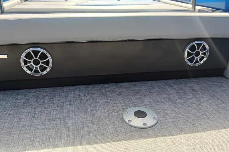 Slide: The Image of 2026 Sun Tracker Party Barge 22 RF XP3 interior with speakers and textured flooring. - 13