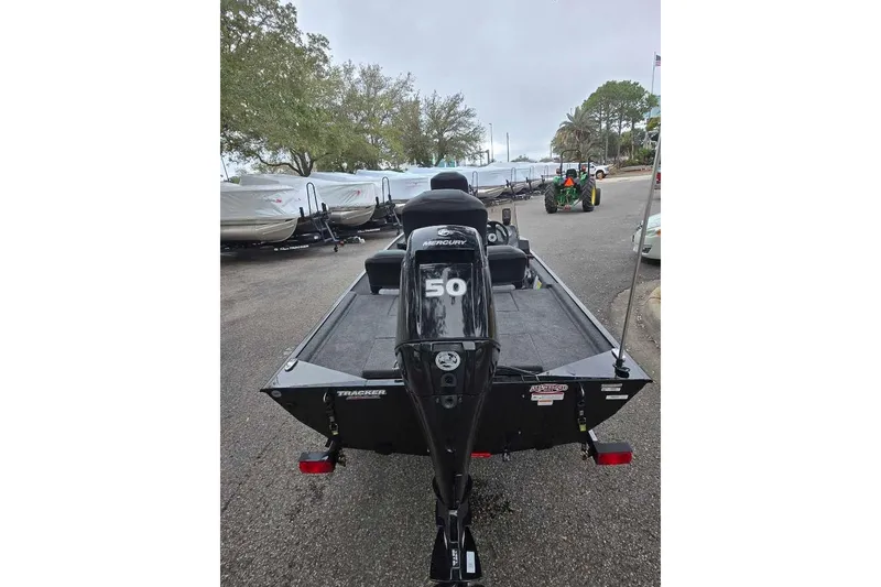 Slide: The Image of 2026 Tracker Bass Tracker Classic XL boat with Mercury engine, parked outdoors. - 3