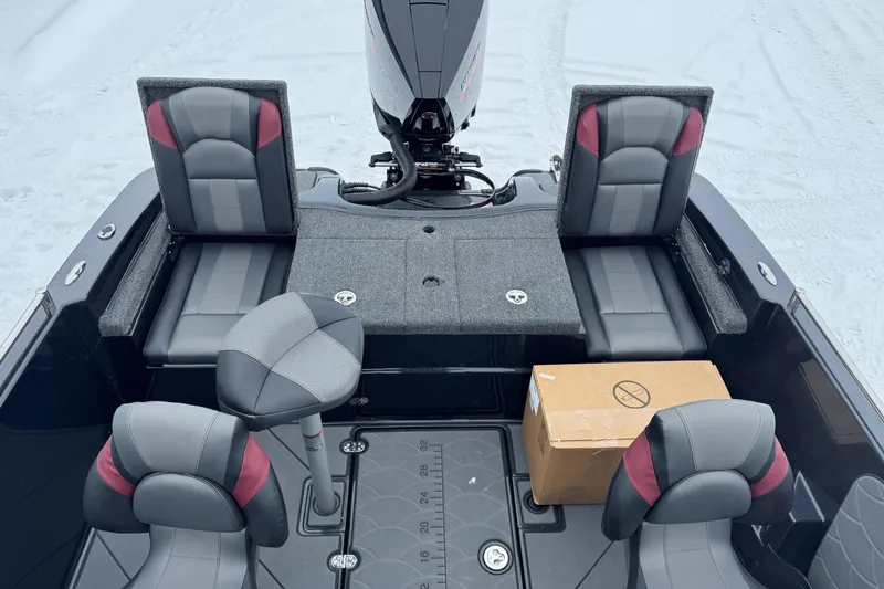 Slide: The Image of 2026 Nitro ZV19 Sport boat interior with seating and motor, featuring a cardboard box. - 10