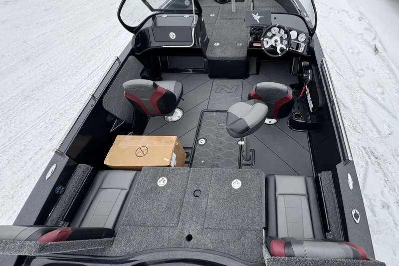 Slide: The Image of 2026 Nitro ZV19 Sport boat interior with seating and dashboard, parked on snow. - 11