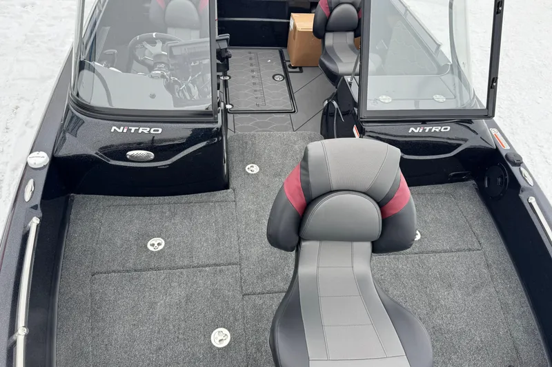 Slide: The Image of 2026 Nitro ZV19 Sport boat interior with gray and red seating, open windshield. - 8