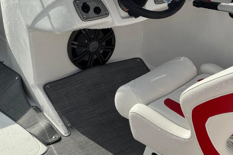 Slide: The Image of Interior of 2025 Tahoe 2150 boat with white and red seating, speaker, and steering wheel. - 3