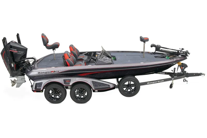 Slide: The Image of 2026 Ranger Z519R boat interior with steering wheel and seating, parked outdoors. - 9