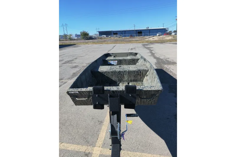 Slide: The Image of 2026 Tracker Grizzly 15 Jon boat on trailer in parking lot. - 3