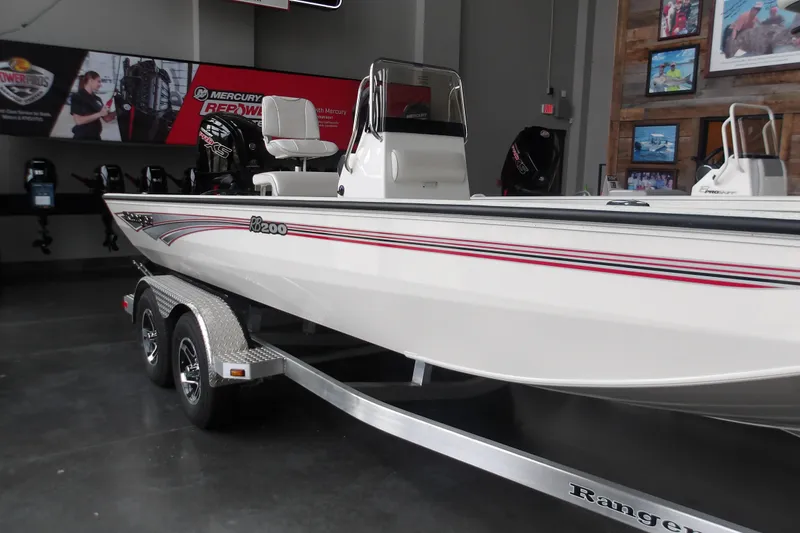 The Image of 2026 Ranger RB200 boat on display in showroom with Mercury engine. - 0