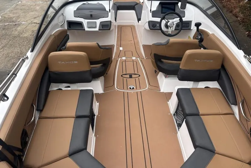 Slide: The Image of 2026 Tahoe 210 S boat interior with tan and black seating, modern dashboard, and spacious layout. - 113