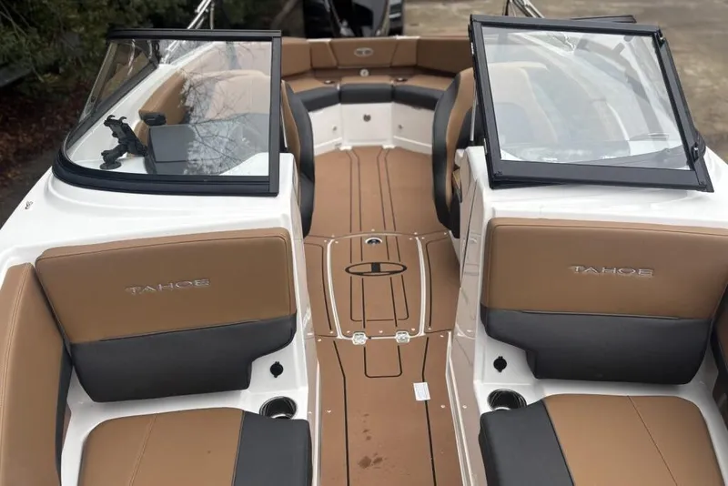 Slide: The Image of 2026 Tahoe 210 S boat interior with tan and black seating, open windshield. - 114