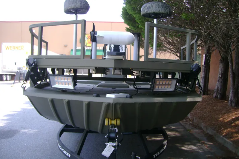 Slide: The Image of 2026 Tracker Grizzly 2072 CC Sportsman boat, rear view with mounted lights and seating. - 3