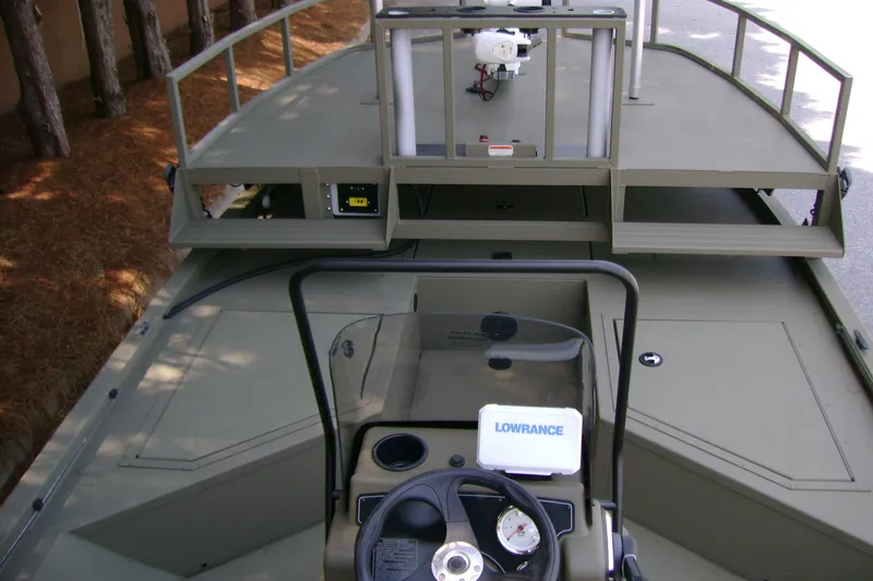 Slide: The Image of 2026 Tracker Grizzly 2072 CC Sportsman boat interior with steering console and equipment. - 5