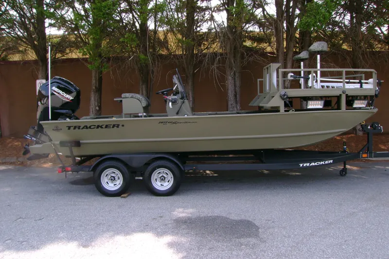 The Image of 2026 Tracker Grizzly 2072 CC Sportsman boat on trailer, parked outdoors. - 0