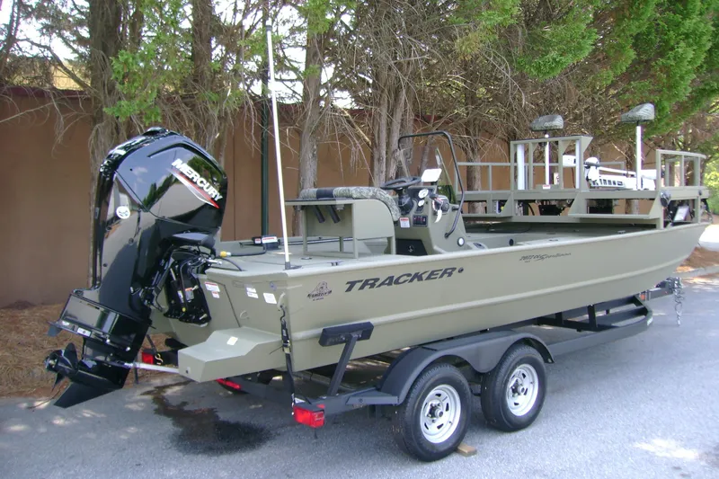 Slide: The Image of 2026 Tracker Grizzly 2072 CC Sportsman boat on trailer, featuring Mercury outboard motor. - 2