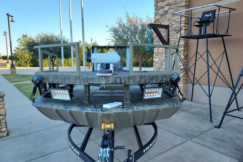 Slide: The Image of 2026 Tracker Grizzly 2072 CC Sportsman boat on trailer, outdoor display setting. - 3