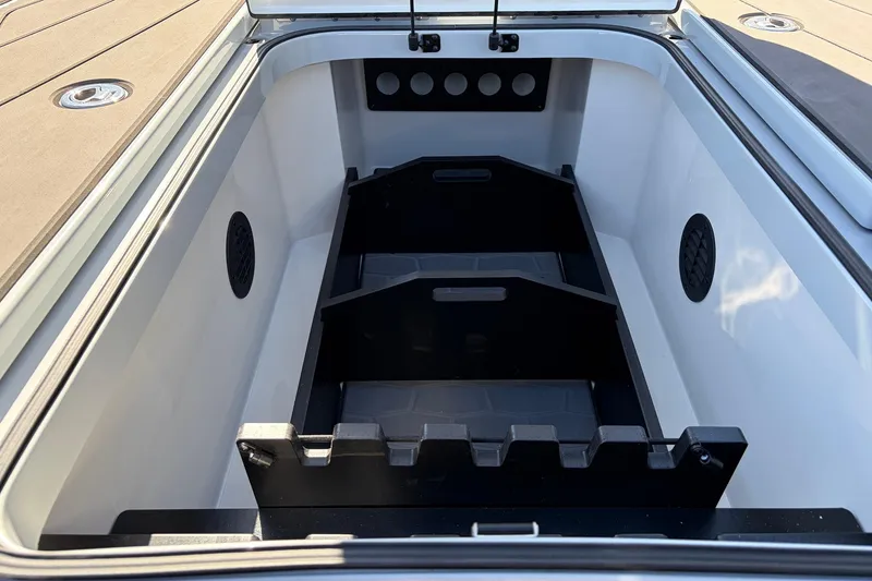 Slide: The Image of 2026 Ranger Z521R Cup-Equipped boat storage compartment, open lid, organized interior design. - 26