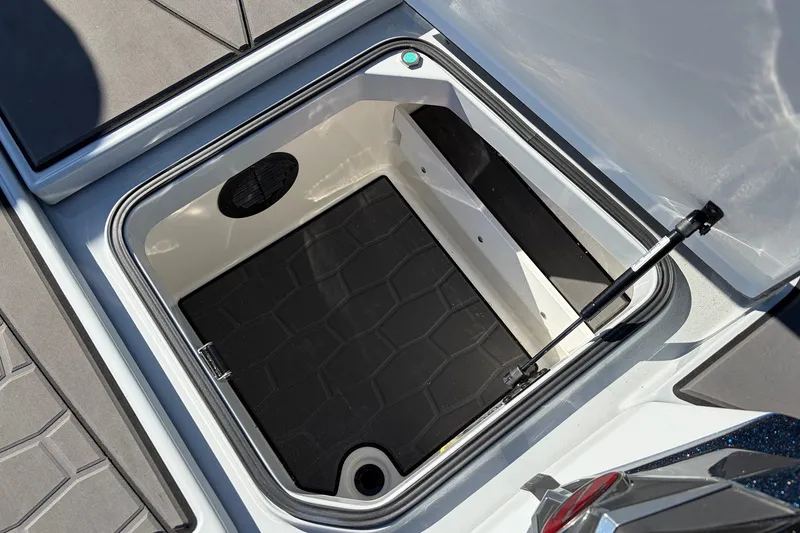 Slide: The Image of Open storage compartment in 2026 Ranger Z521R Cup-Equipped boat, featuring hydraulic lift support. - 32