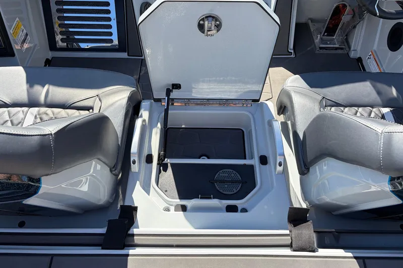 Slide: The Image of 2026 Ranger Z521R Cup-Equipped boat interior with open storage compartment and cushioned seats. - 58