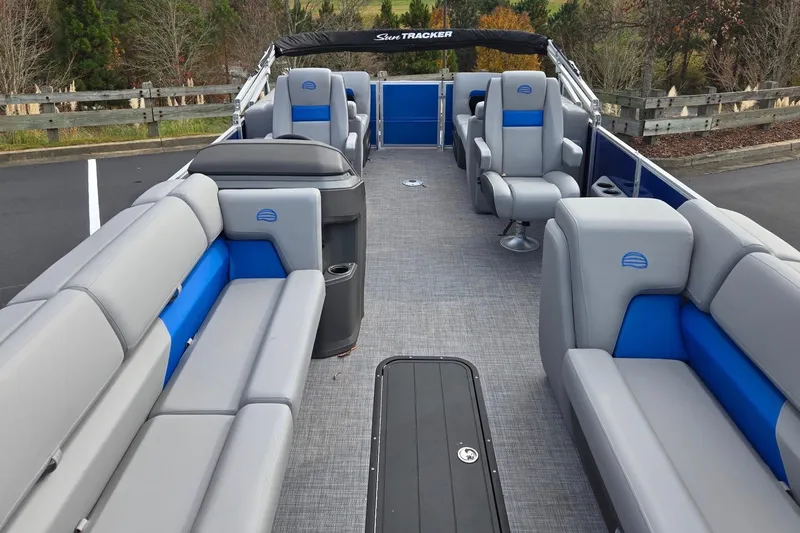 Slide: The Image of 2026 Sun Tracker Party Barge 24 XP3 interior with gray and blue seating. - 2