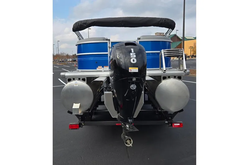 Slide: The Image of 2026 Sun Tracker Party Barge 24 XP3 pontoon boat with 150 HP engine, rear view. - 4