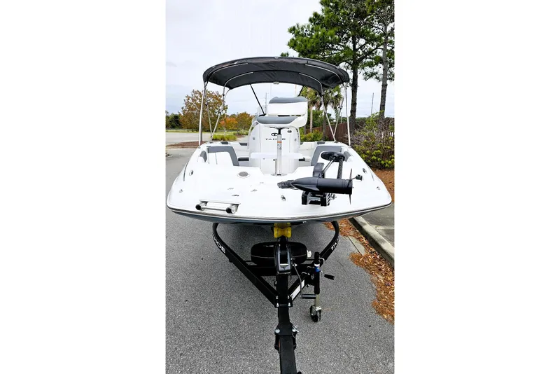 Slide: The Image of 2026 Tahoe 2150 CC boat on trailer with Mercury engine, parked outdoors. - 5