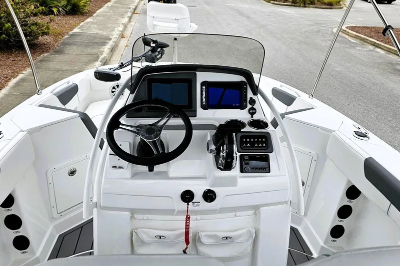 Slide: The Image of 2026 Tahoe 2150 CC boat interior with seating, table, and steering console. - 8