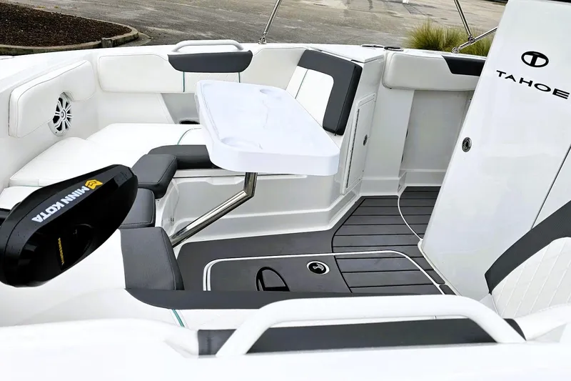 Slide: The Image of 2026 Tahoe 2150 CC boat interior with seating, table, and Minn Kota motor. - 9