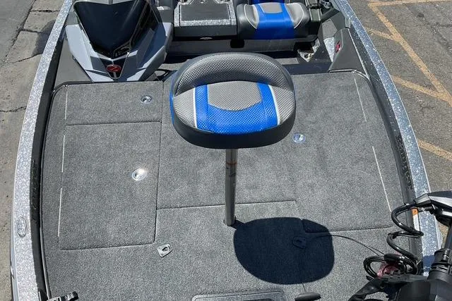 Slide: The Image of 2026 Ranger Z518 boat interior with gray and blue seating, spacious deck, and modern design. - 10