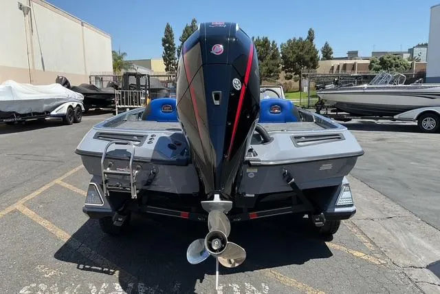 Slide: The Image of 2026 Ranger Z518 boat with powerful outboard motor, parked outdoors. - 12