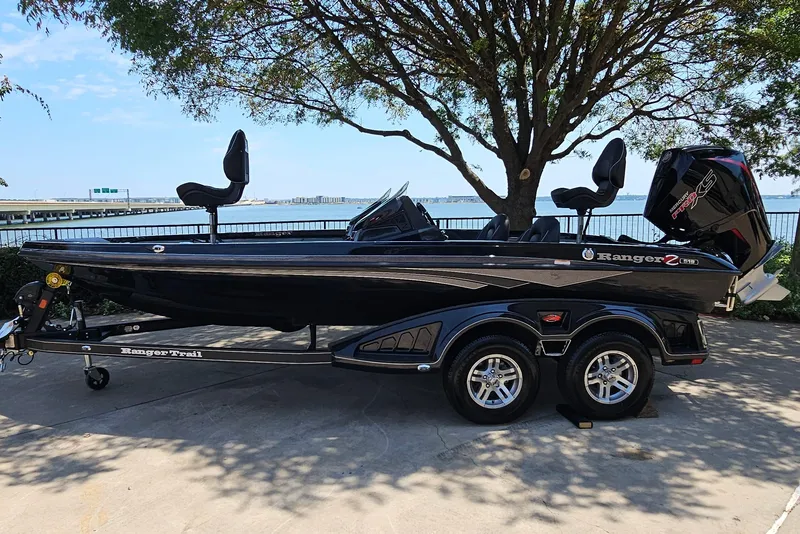 The Image of 2026 Ranger Z518 boat parked by waterfront, featuring sleek design and dual seats. - 0