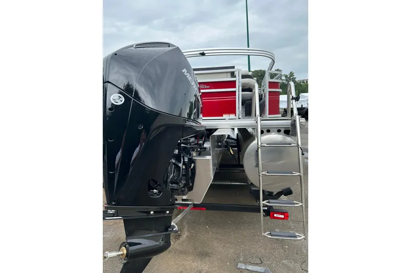 Slide: The Image of 2026 Sun Tracker Fishin' Barge 22 XP3 with powerful outboard motor and ladder. - 3