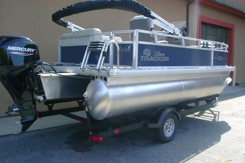 Slide: The Image of 2026 Sun Tracker Bass Buggy 16 XL Select pontoon boat with Mercury outboard motor. - 2